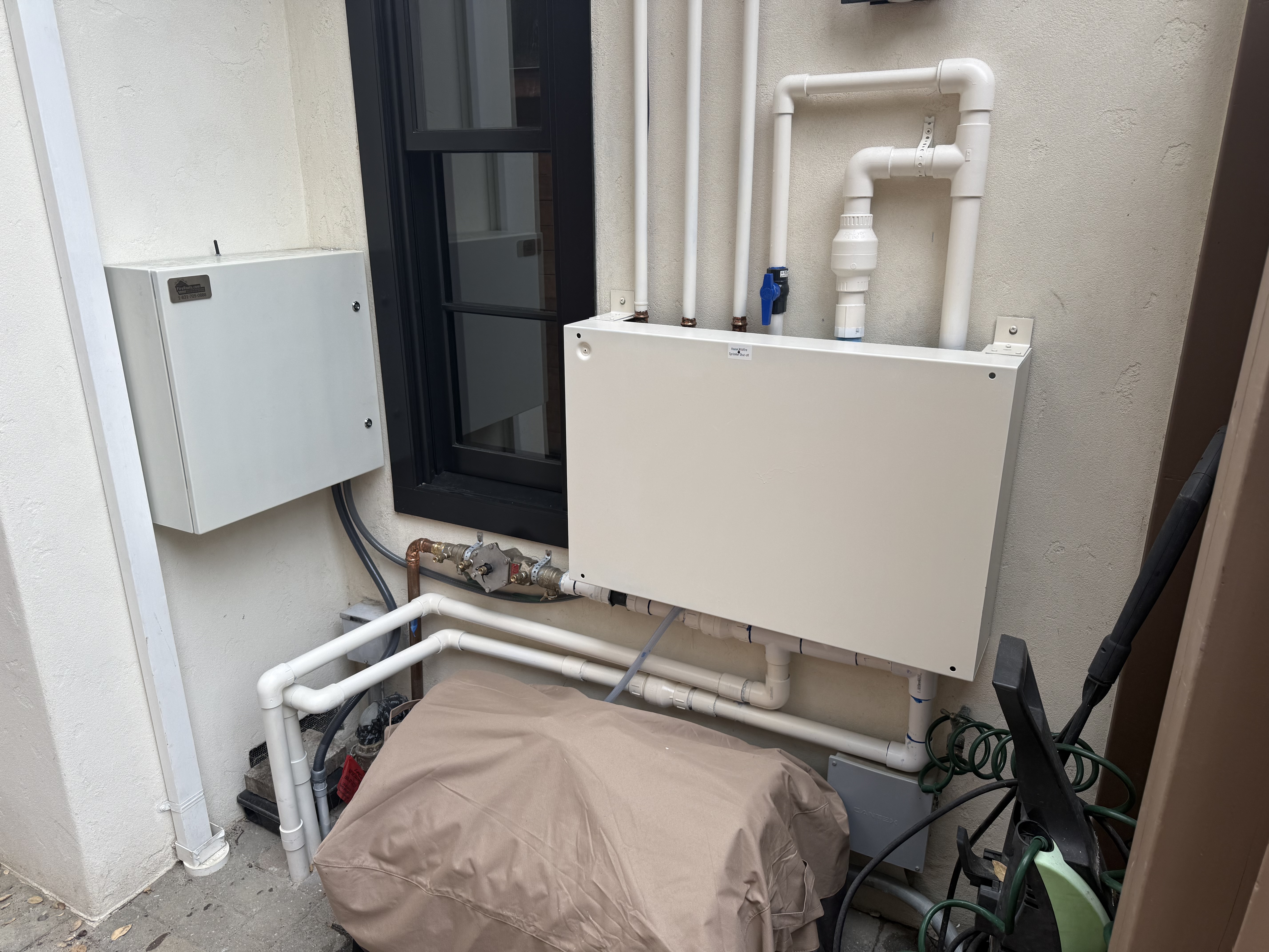 FireRoofs control enclosure with plumbing manifold and valve assembly